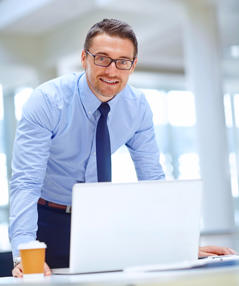 An IT professional monitors from his laptop. An IT professional monitors from his laptop.