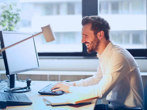 A virtual executive assistant engages in a video call on his computer.