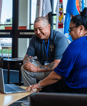 Colleagues reviewing information on a laptop