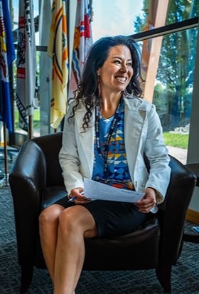 Interviewer sitting in chair smiling