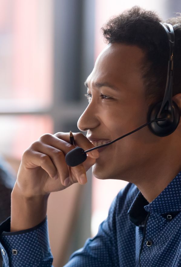 Smiling young african businessman call center agent laugh at workplace