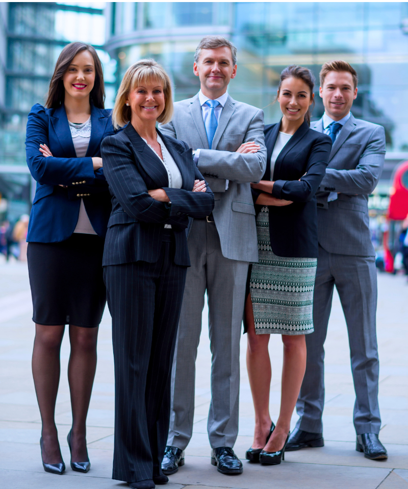A team of Managed Services professionals standing outside an office building. A team of Managed Services professionals standing outside an office building.