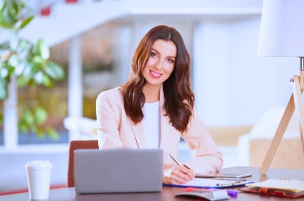 Admin Professional writing on a clipboard