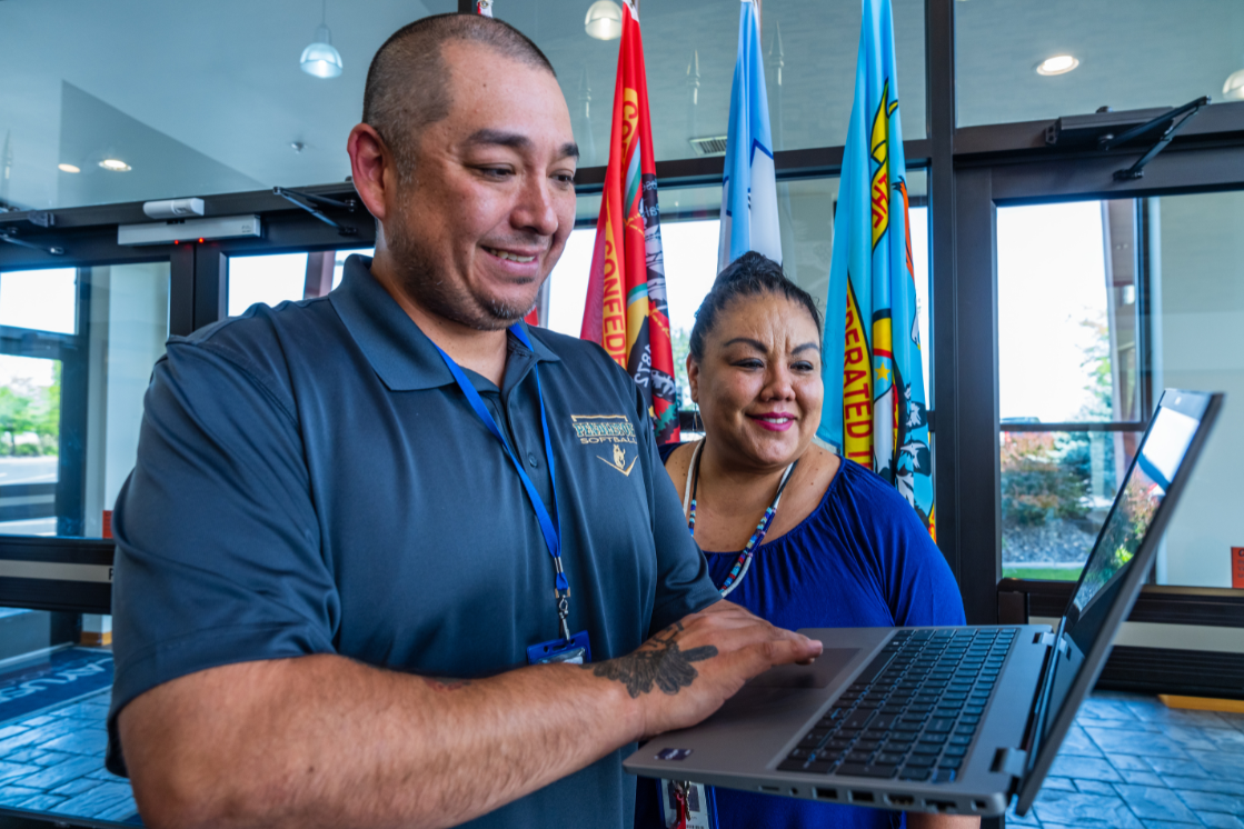Colleagues work together on a laptop. Colleagues work together on a laptop.