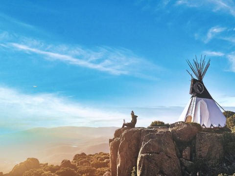 The span of technology brings culture and regions together as see when the teepee meets a person on their laptop.