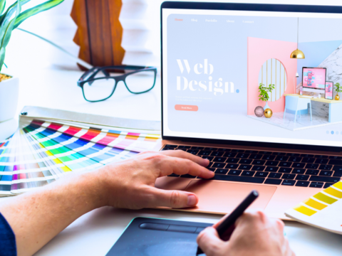 A website designer works at matching color palettes with layout.