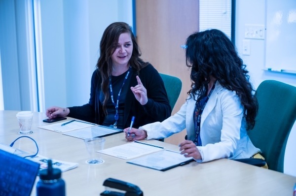 Two females in discussion in a board meeting
