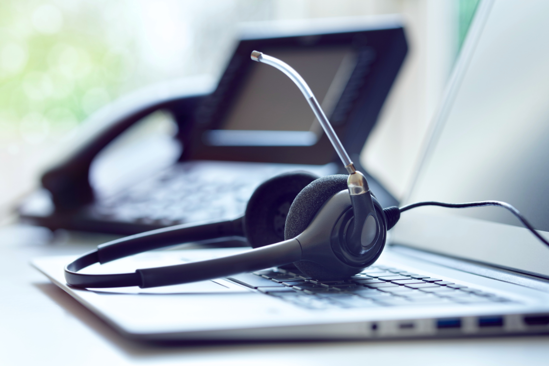 The tools of a remote technician include a laptop, phone, and headset for hands-free assistance.