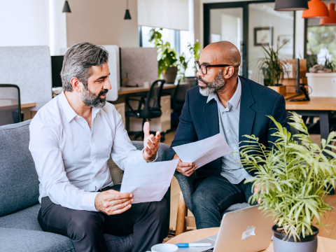 Colleagues discuss portfolio management. Colleagues discuss portfolio management.
